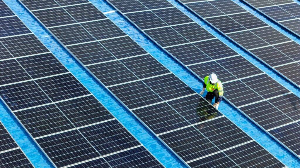 Technician working to construct solar panels system